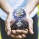 - concept hands holding earth bulb 683x1024 1